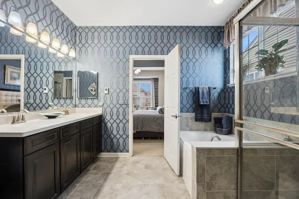 a en suite bathroom with a sink a mirror and a bathtub