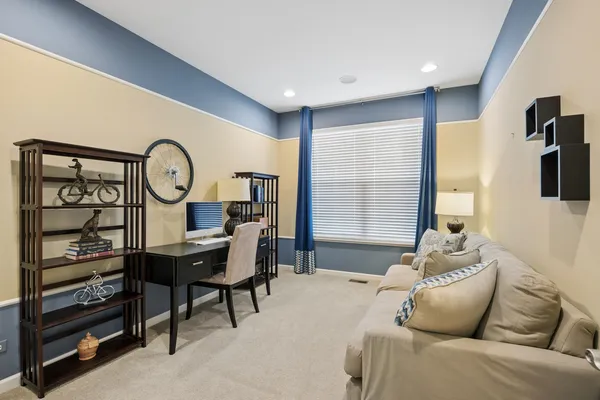 a living room with furniture a flat screen tv and a window
