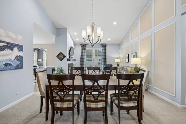 a view of a dining room with furniture and chandelier