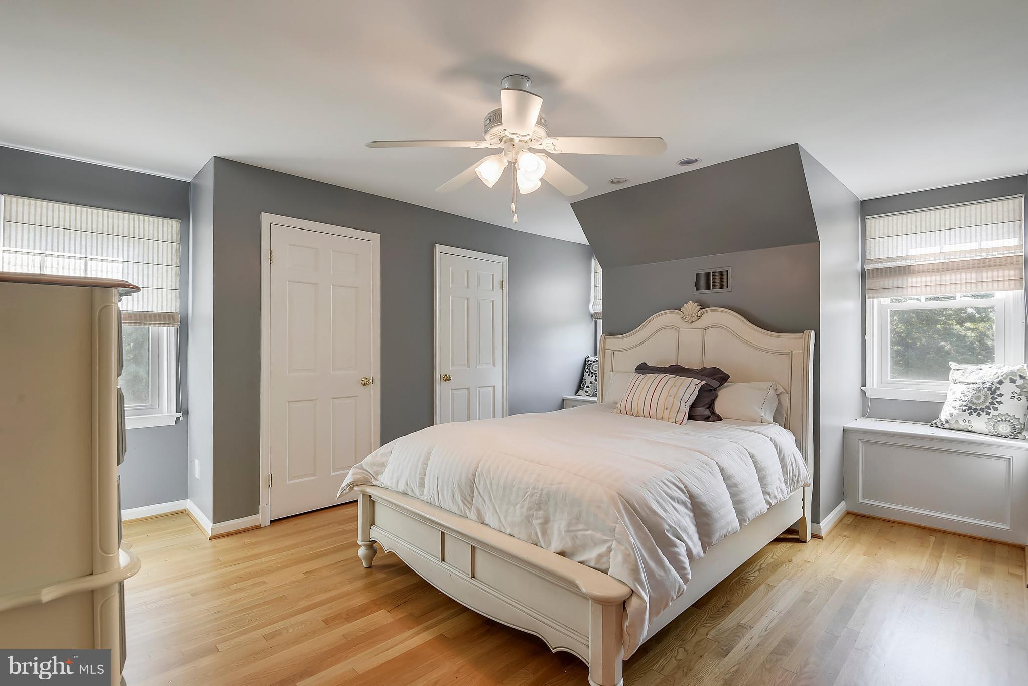 12408 Beall Spring Road Potomac, MD 20854 - Photo 18 of 30 a bedroom with a large bed chandelier and a window