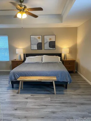 a bedroom with a bed and a chandelier