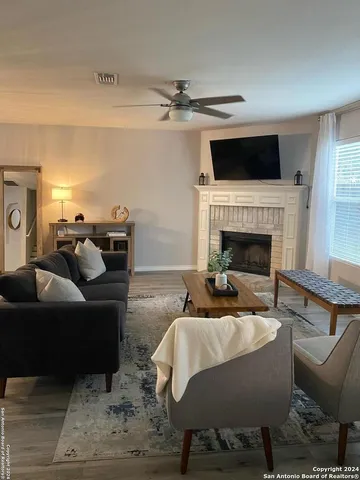 a living room with furniture and a fireplace