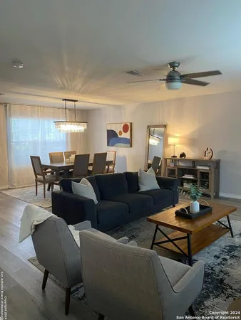 a living room with furniture a rug and a chandelier