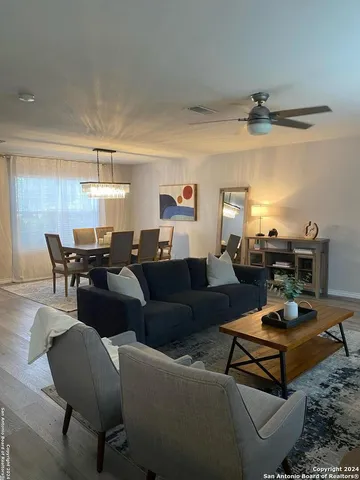 a living room with furniture a rug and a chandelier