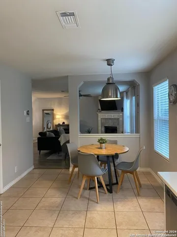 a dining room with a table and chairs