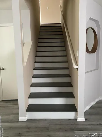 a view of entryway and hall with wooden floor