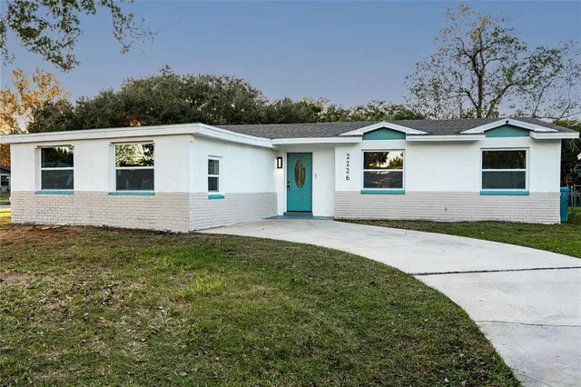 a house that has a tree in front of it