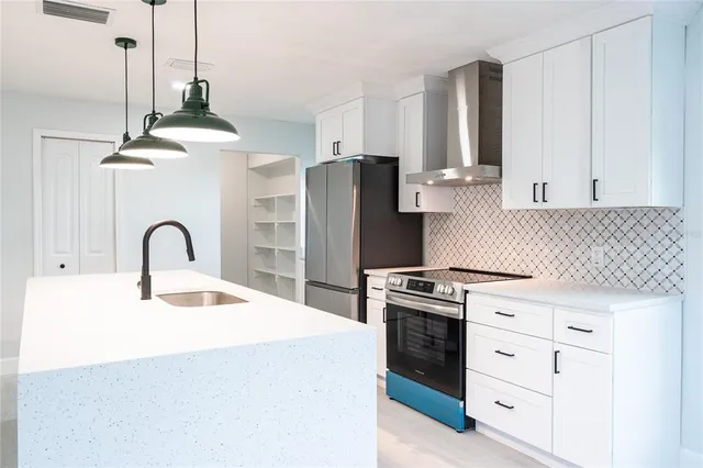 a kitchen with granite countertop a stove and a sink