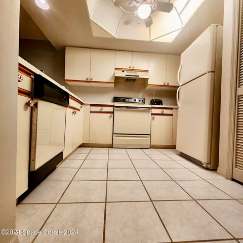 a kitchen with a sink a stove and refrigerator