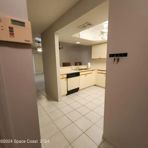a kitchen with a refrigerator and white cabinets