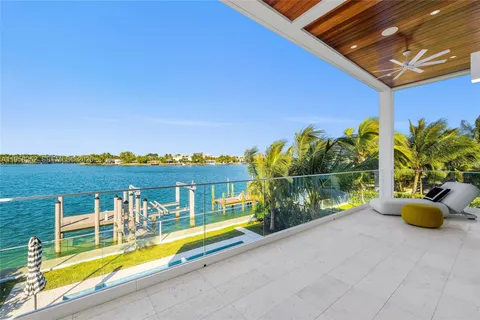 a view of a swimming pool with a patio and a garden