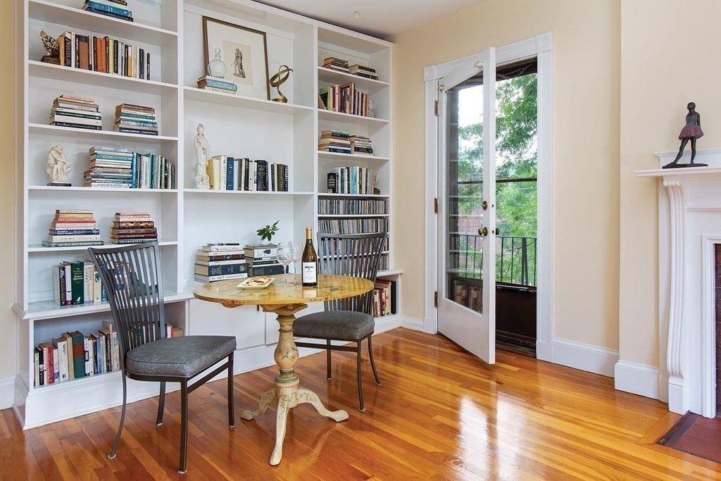 1 Regent Circle, Unit 2 Brookline, MA 02445 - Photo 3 of 10 a living room with furniture and a book shelf