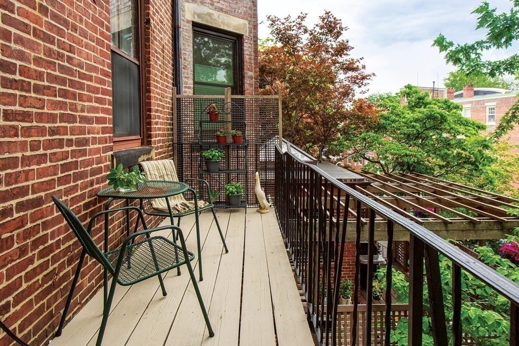 1 Regent Circle, Unit 2 Brookline, MA 02445 - Photo 4 of 10 a view of balcony with wooden floor and fence