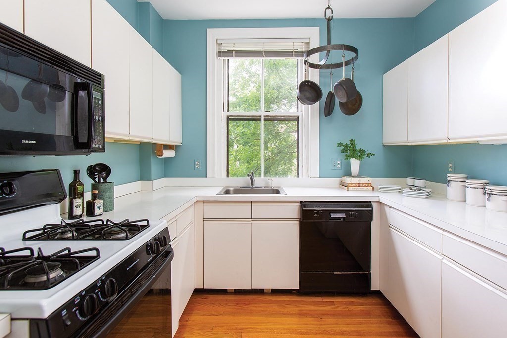 1 Regent Circle, Unit 2 Brookline, MA 02445 - Photo 5 of 10 a kitchen with a sink stove and microwave