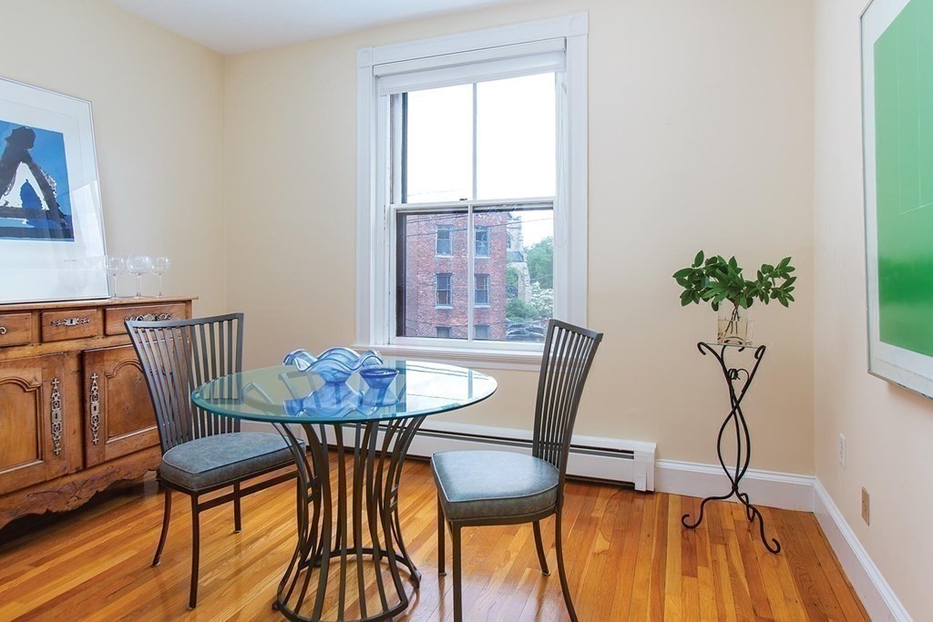 1 Regent Circle, Unit 2 Brookline, MA 02445 - Photo 7 of 10 a view of a dining room with furniture and wooden floor
