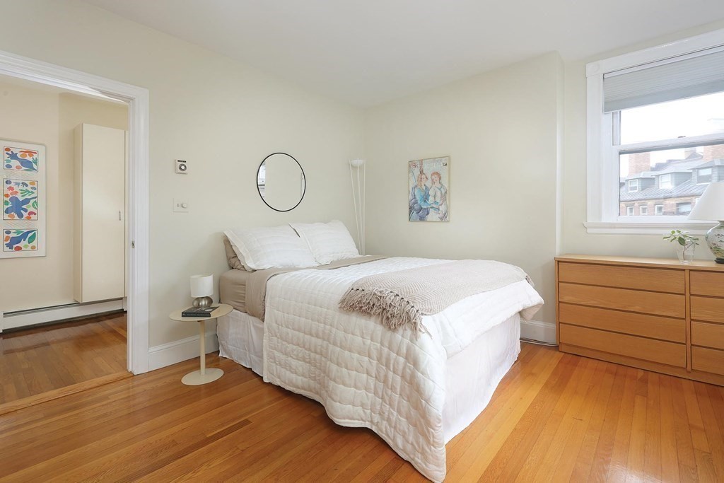 1 Regent Circle, Unit 2 Brookline, MA 02445 - Photo 9 of 10 a bedroom with a bed and window