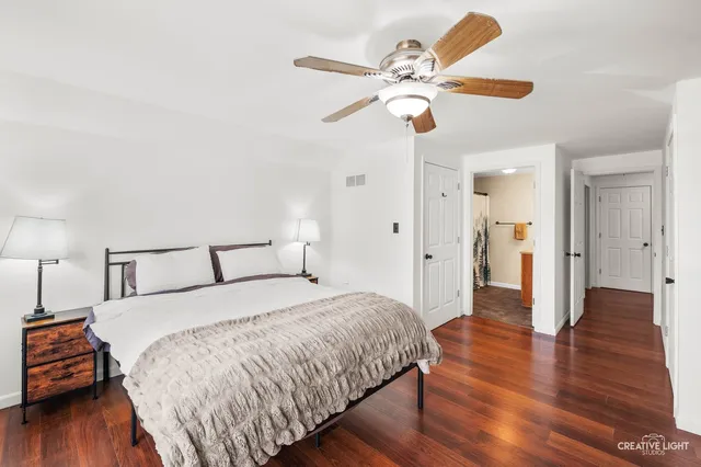 a spacious bedroom with a bed and a chandelier