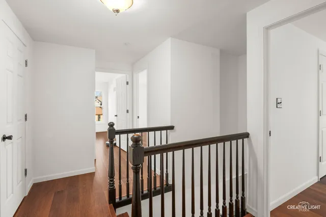 a view of hallway with wooden floor
