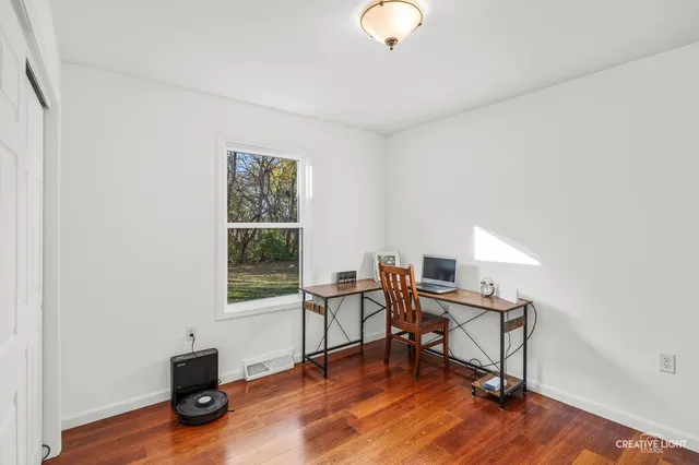 a workspace with furniture hardwood and a window