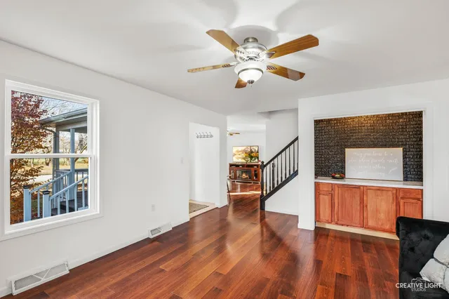 a view of entryway and hall with wooden floor