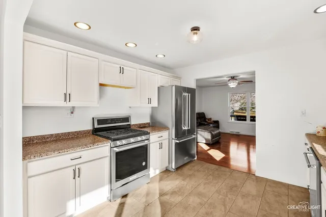 a kitchen with stainless steel appliances granite countertop a stove and a refrigerator
