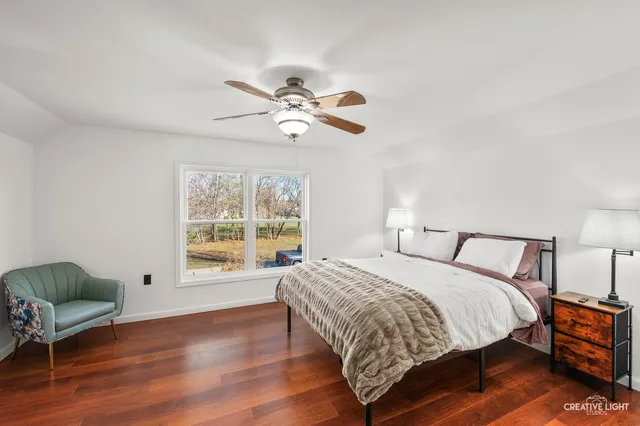a bedroom with a bed window and a couch