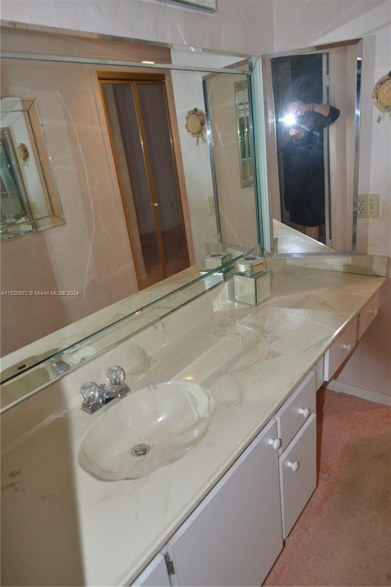 Ives Estates Miami, FL 33179 - Photo 11 of 17 a bathroom with a sink and a mirror