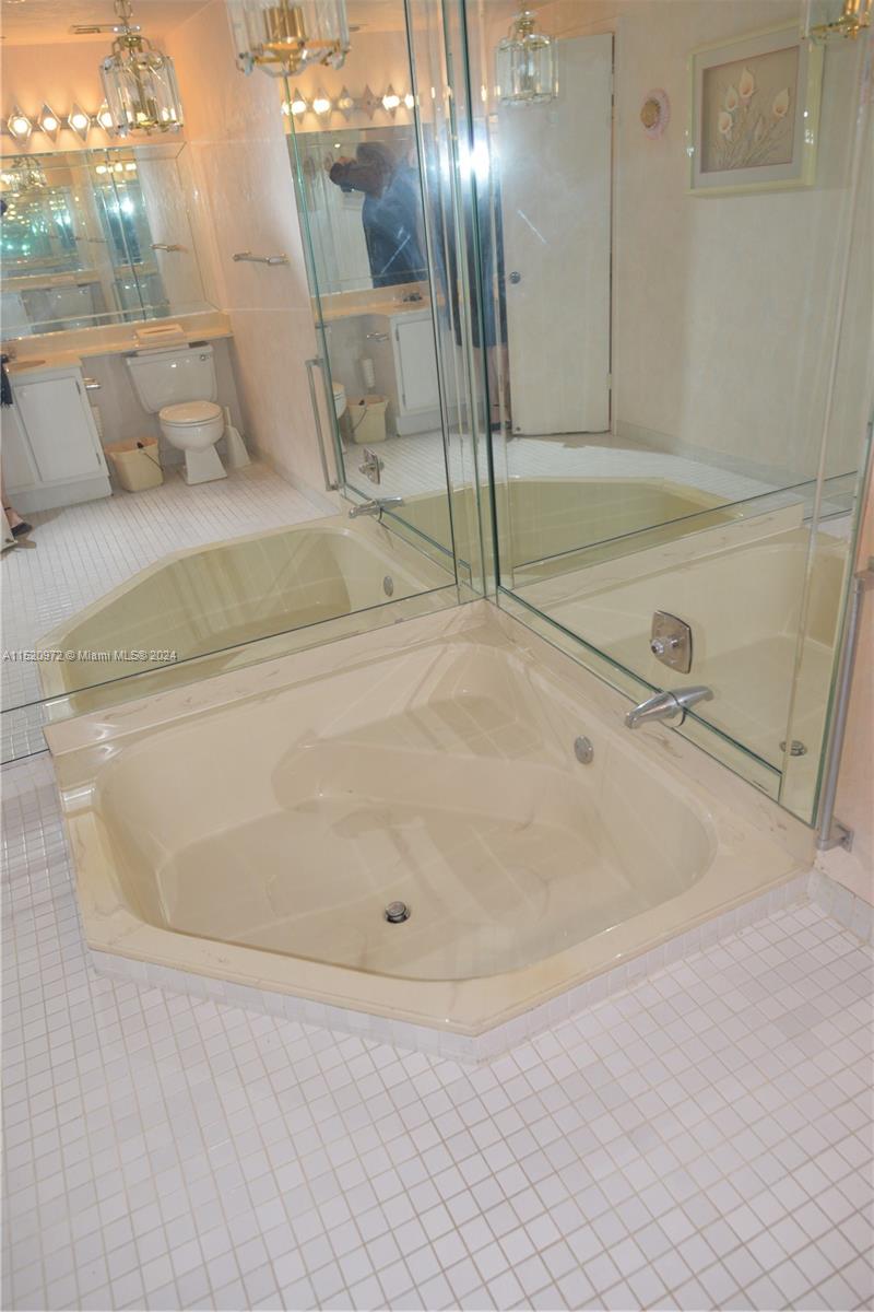 Ives Estates Miami, FL 33179 - Photo 12 of 17 a bathroom with a tub and shower