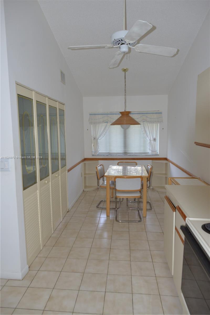 Ives Estates Miami, FL 33179 - Photo 4 of 17 a kitchen with stainless steel appliances a stove a table and chair