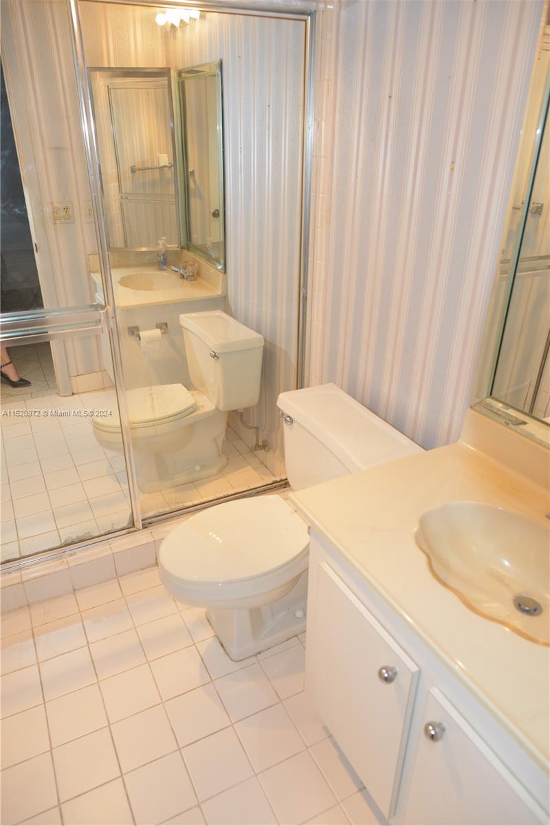 Ives Estates Miami, FL 33179 - Photo 9 of 17 a bathroom with a sink a toilet and shower