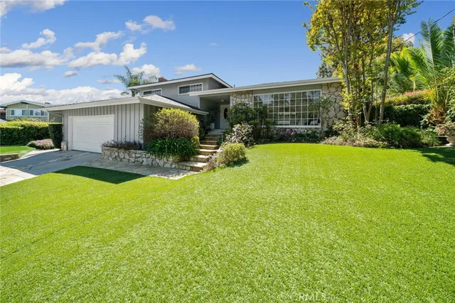 a front view of a house with garden