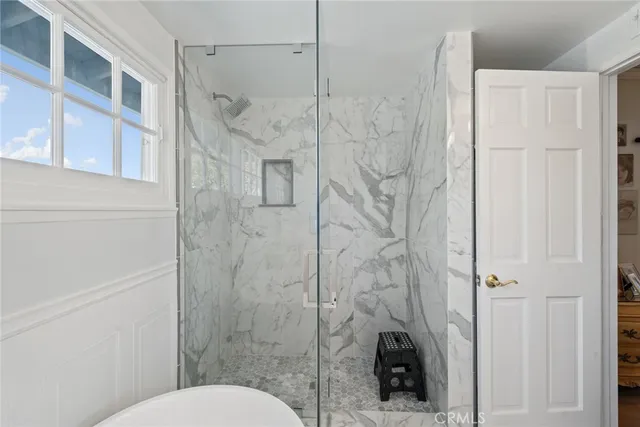a white bath tub sitting next to a toilet
