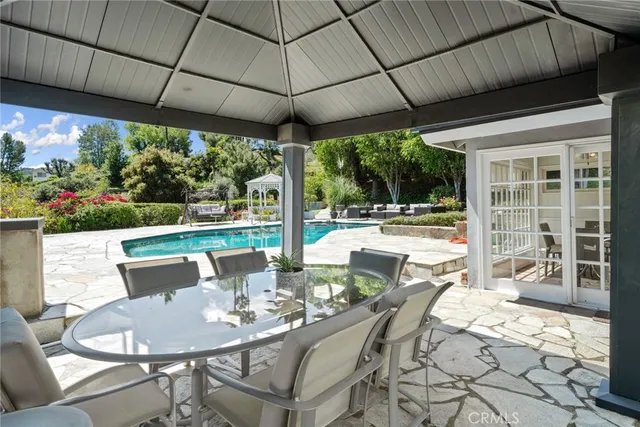 a view of a swimming pool with an outdoor space and seating area