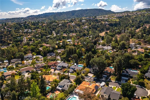 an aerial view of multiple houses with yard