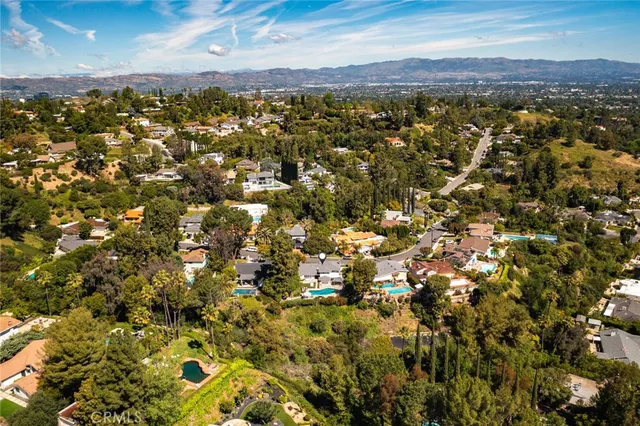 an aerial view of a house with swimming pool garden and patio