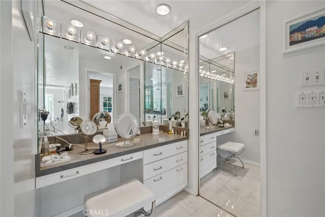 a large white kitchen with a large window and stainless steel appliances