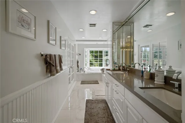 a large white kitchen with a large window