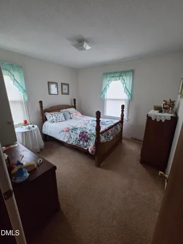 a bed room with bed and window