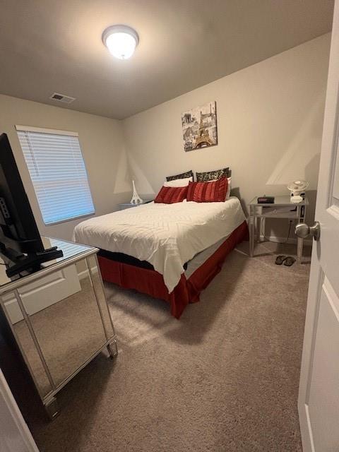 357 Indian Lake Trail Villa Rica, GA 30180 - Photo 19 of 26 a bedroom with a bed and a flat tv screen on the dresser