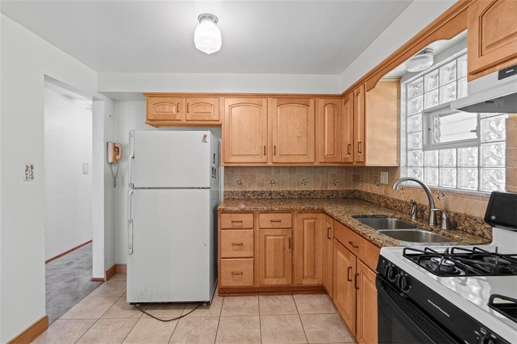 152 Malcolm Pittsburgh, PA 15214 - Photo 16 of 31 a kitchen with a refrigerator a stove a sink and a window