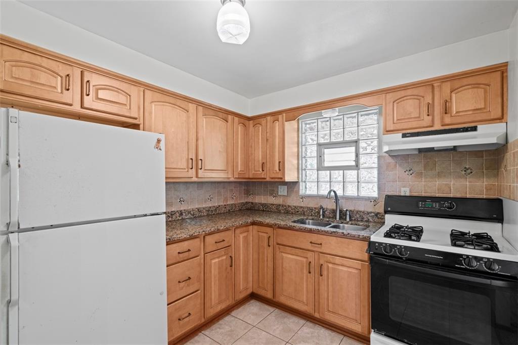 152 Malcolm Pittsburgh, PA 15214 - Photo 17 of 31 a kitchen with stainless steel appliances granite countertop a refrigerator stove sink and cabinets