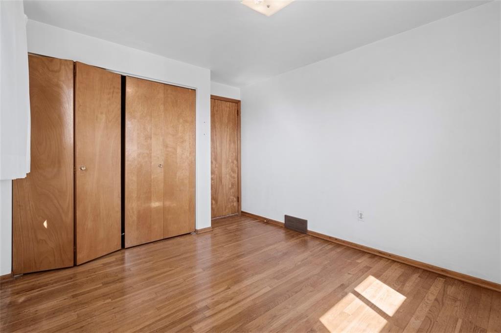 152 Malcolm Pittsburgh, PA 15214 - Photo 24 of 31 an empty room with wooden floor and windows