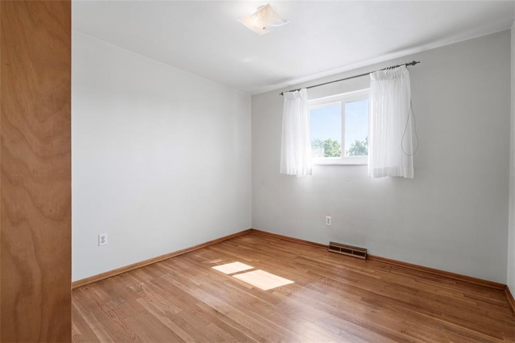 152 Malcolm Pittsburgh, PA 15214 - Photo 25 of 31 an empty room with wooden floor and windows