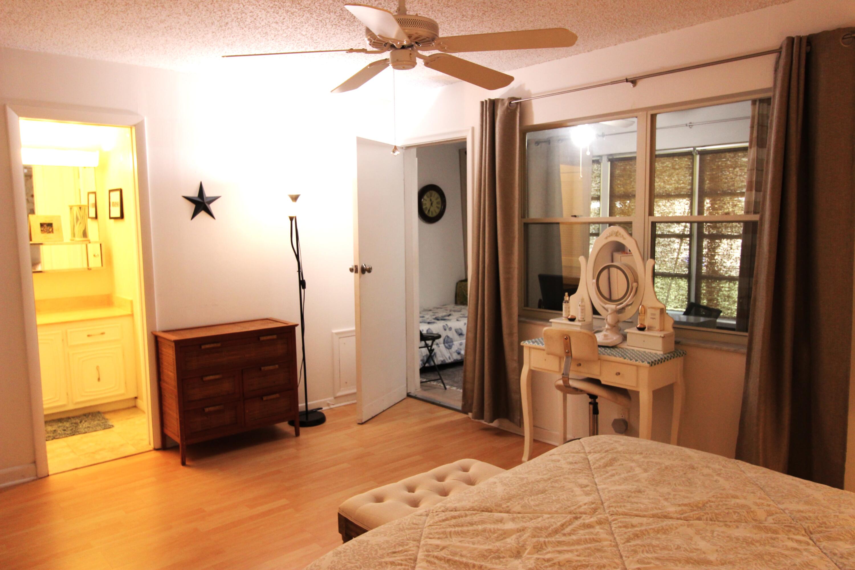 1045 East Circle Terrace, Unit B Delray Beach, FL 33445 - Photo 11 of 12 a bedroom with a bed and a dresser