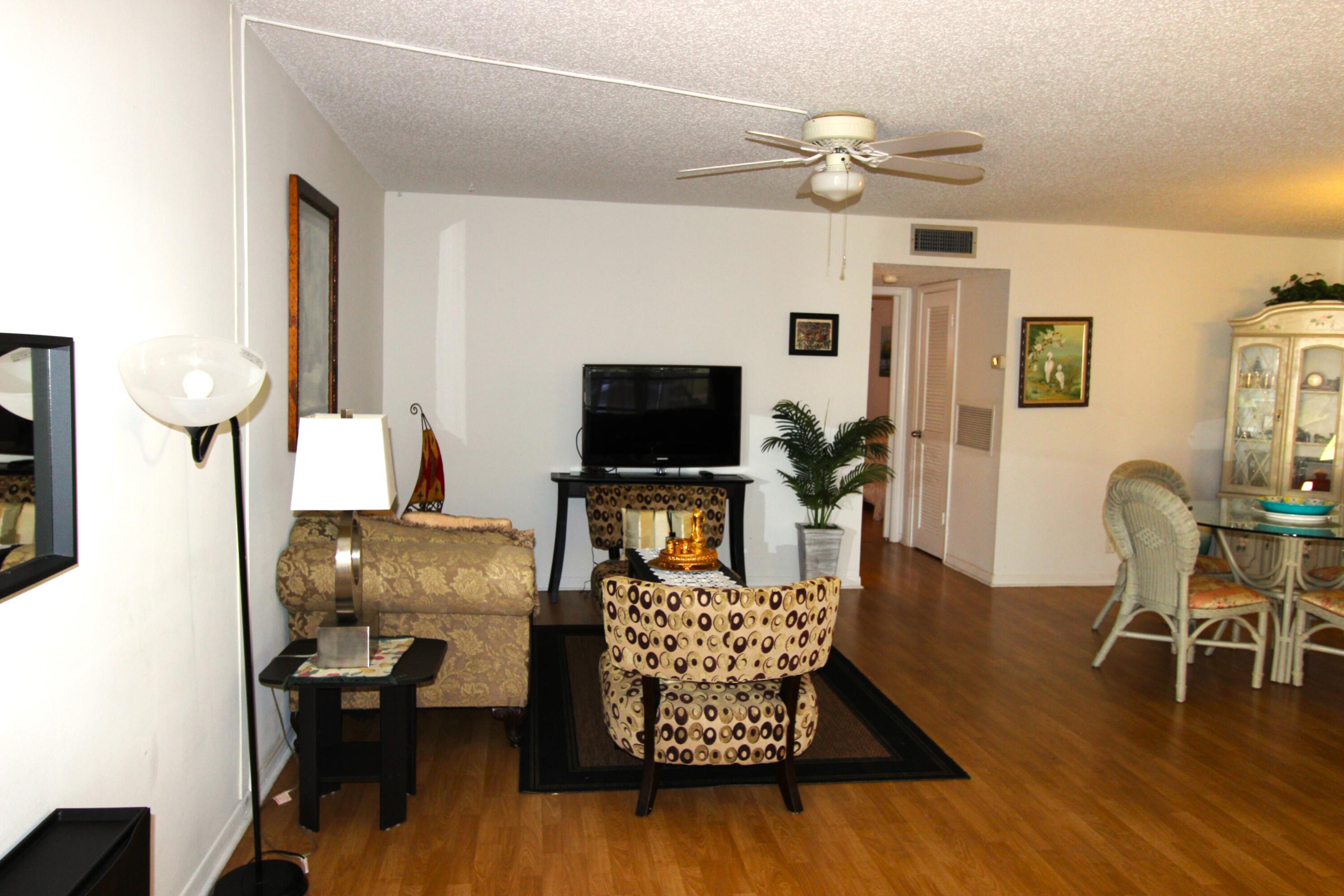 1045 East Circle Terrace, Unit B Delray Beach, FL 33445 - Photo 12 of 12 a living room with furniture and a flat screen tv