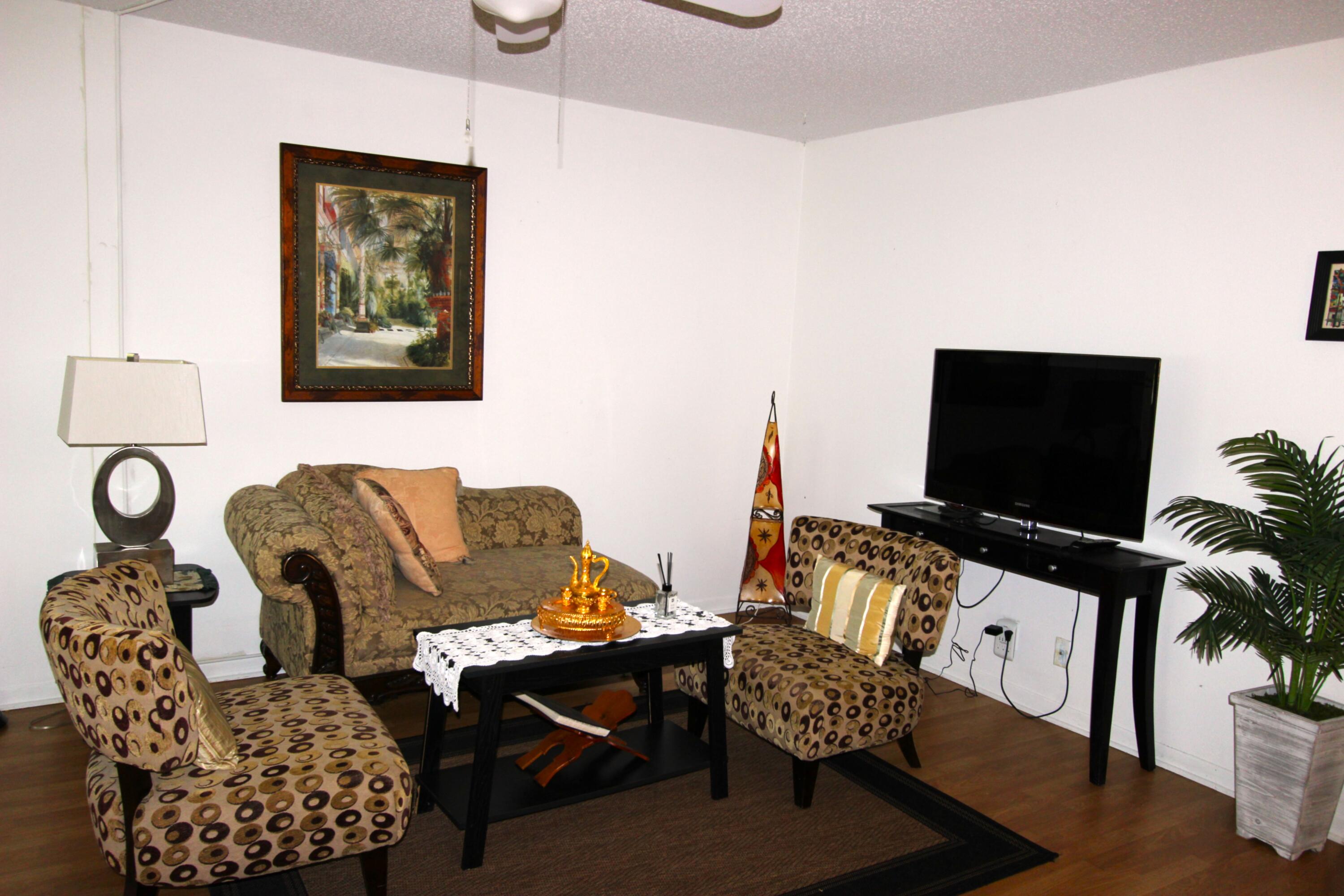 1045 East Circle Terrace, Unit B Delray Beach, FL 33445 - Photo 6 of 12 a living room with furniture and a flat screen tv