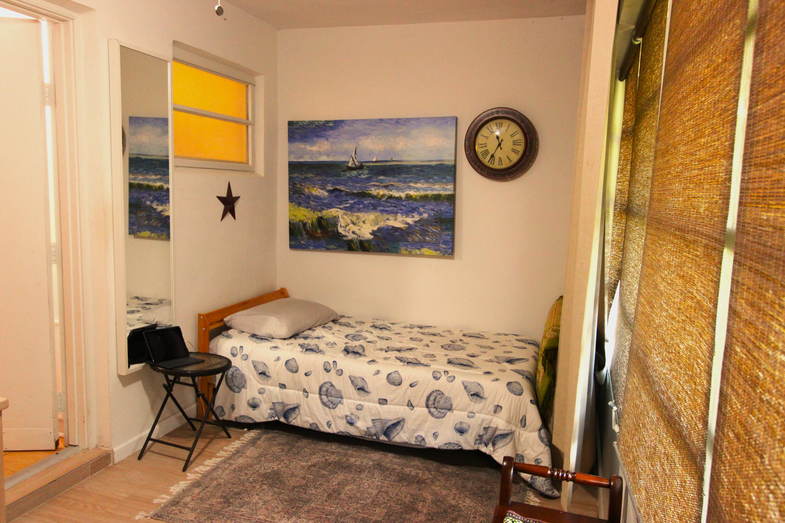 1045 East Circle Terrace, Unit B Delray Beach, FL 33445 - Photo 9 of 12 a bedroom with a bed and a window