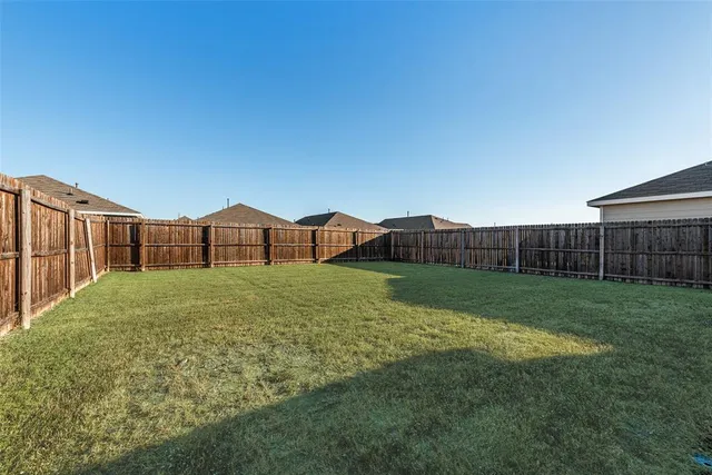 a view of a house with backyard and trampoline