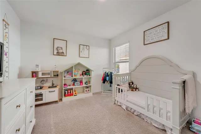 a bedroom with furniture and white walls