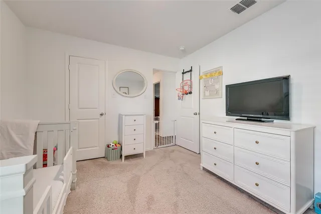 a bedroom with a bed and a flat tv screen in it